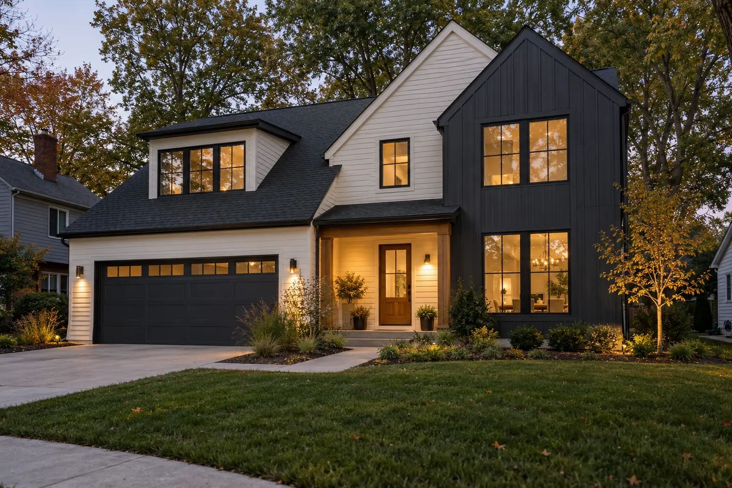 Contemporary home with ivory horizontal siding, charcoal vertical cladding and large windows at dusk